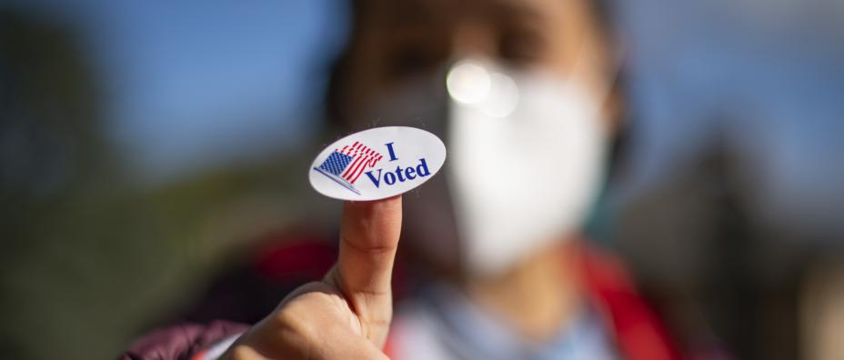 Learner holding I voted sticker